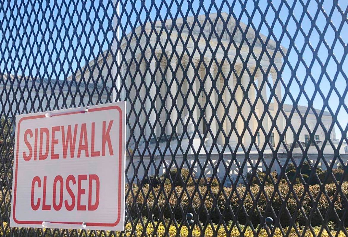 Anti-scaling fencing has been placed in front of the Supreme Court, which stands across the str ...