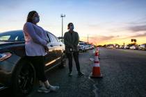 In a Thursday, Jan. 7, 2021, photo, Cindy Rubiano and Trolena Loya stand outside their car as t ...