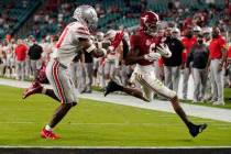 Alabama wide receiver DeVonta Smith scores a touchdown past Ohio State safety Josh Proctor duri ...