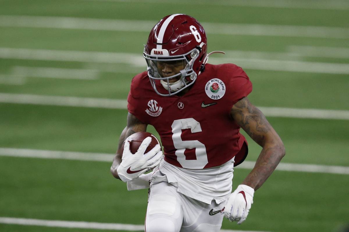 Alabama wide receiver DeVonta Smith (6) gains yardage after a catch in the first half of the Ro ...