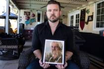 Ethan Bondelid, 40, holds a photograph of his slain father, Alan Bondelid, 70, at his father's ...