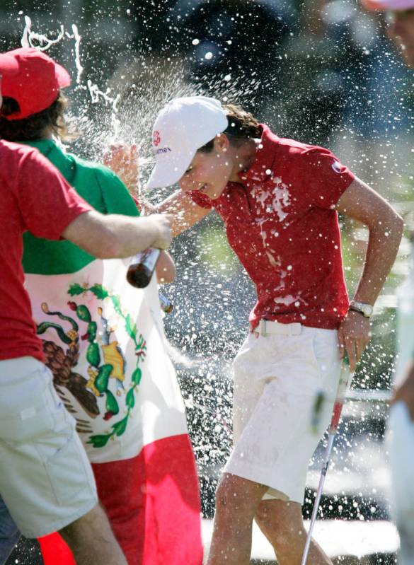 Lorena Ochoa of Mexico is sprayed with champagne and beer by friends and fans after she won the ...