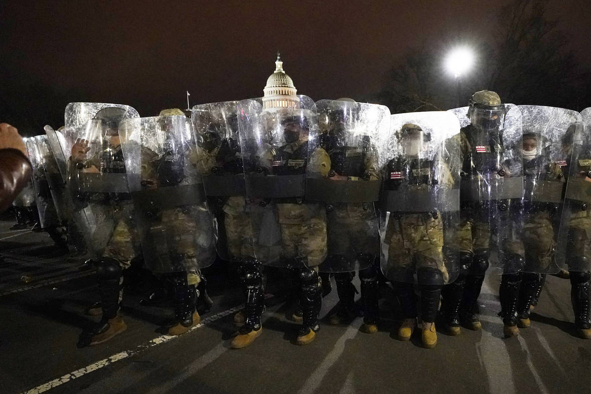 DC National Guard stand outside the Capitol, Wednesday, Jan. 6, 2021, after a day of rioting pr ...