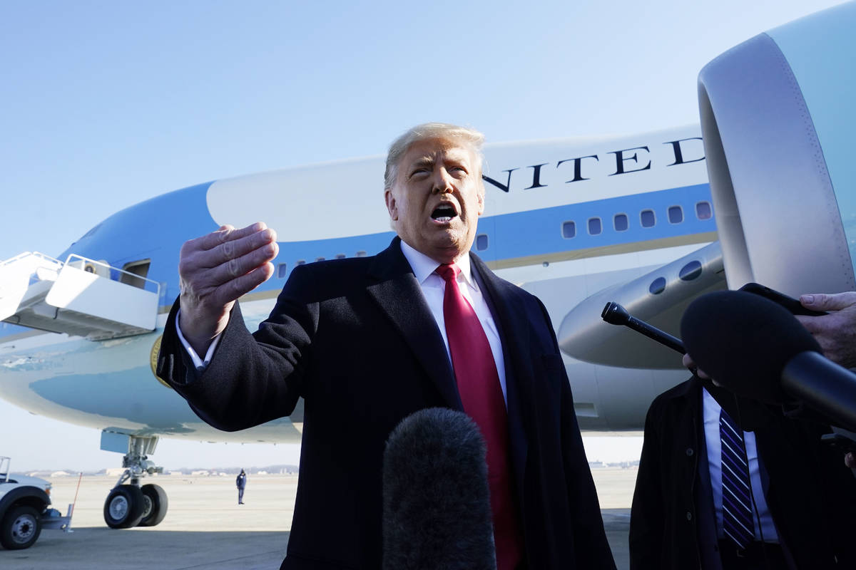 President Donald Trump speaks to the media before boarding Air Force One, at Andrews Air Force ...