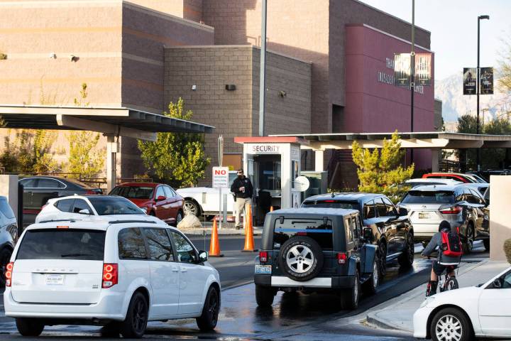 Parents in their cars lined up to enter Faith Lutheran Middle School and High School to drop of ...