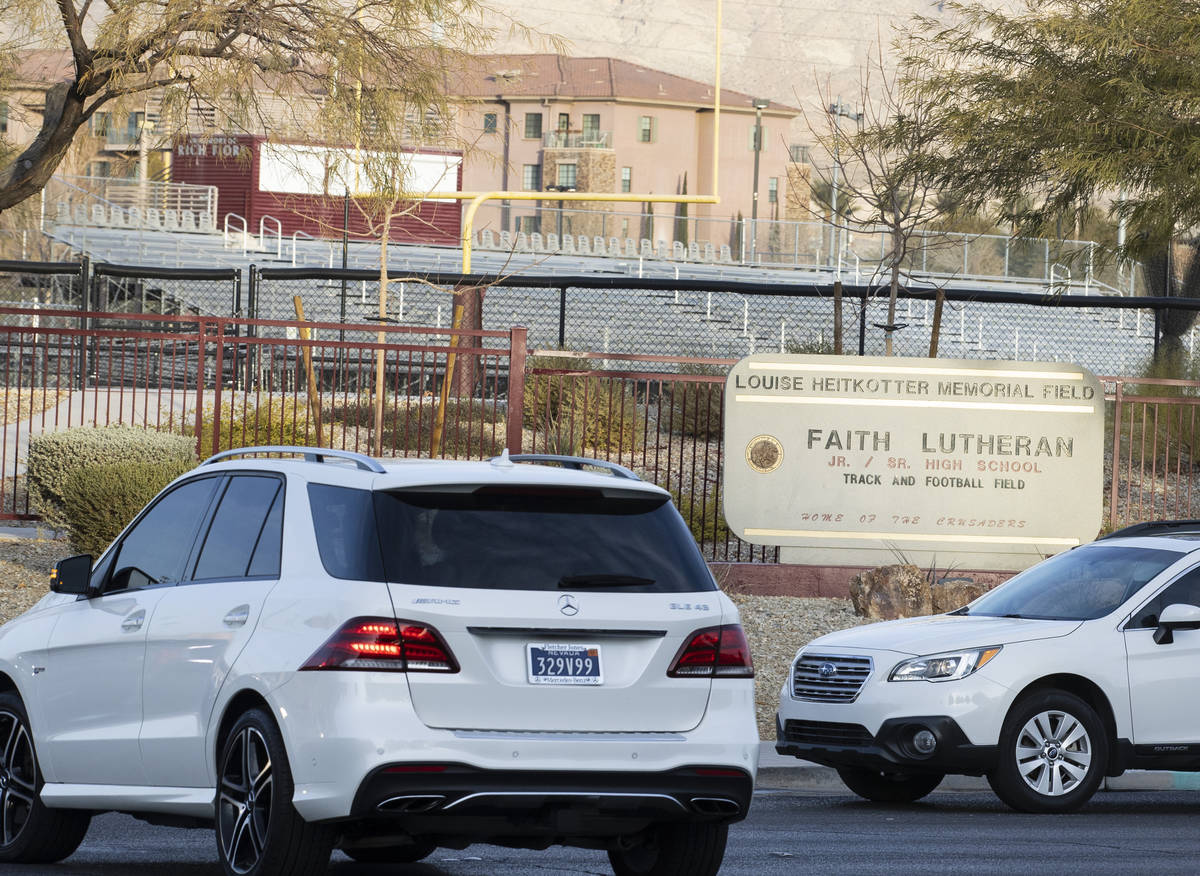 Parents in their cars lined up to enter Faith Lutheran Middle School and High School to drop of ...