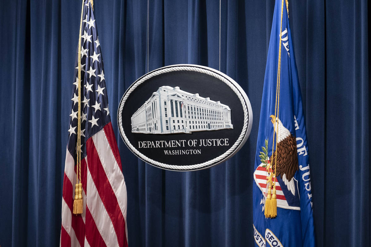 A sign for the Department of Justice is seen ahead of a news conference Tuesday, Jan. 12, 2021, ...