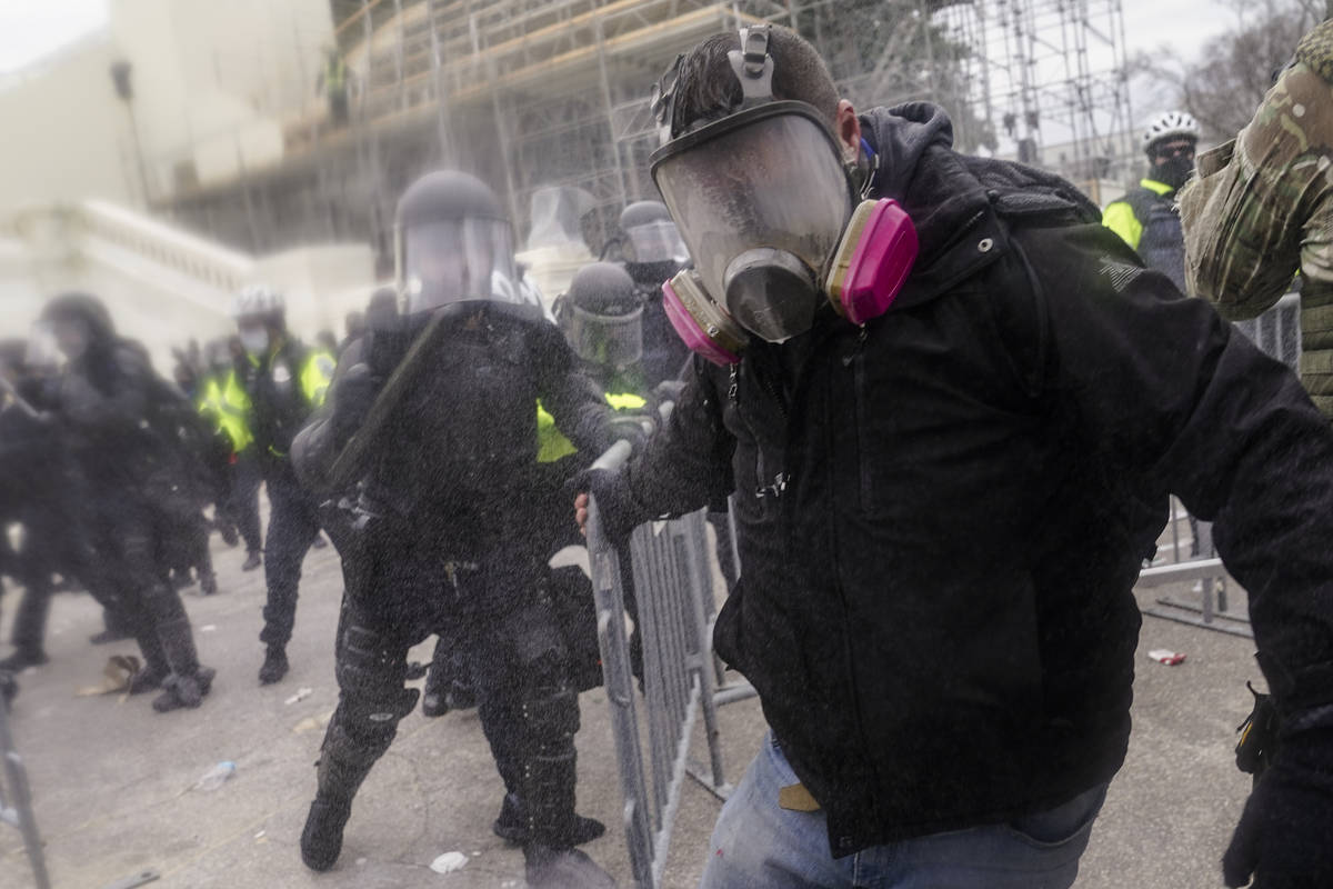 Trump supporters try to break through a police barrier, Wednesday, Jan. 6, 2021, at the Capitol ...