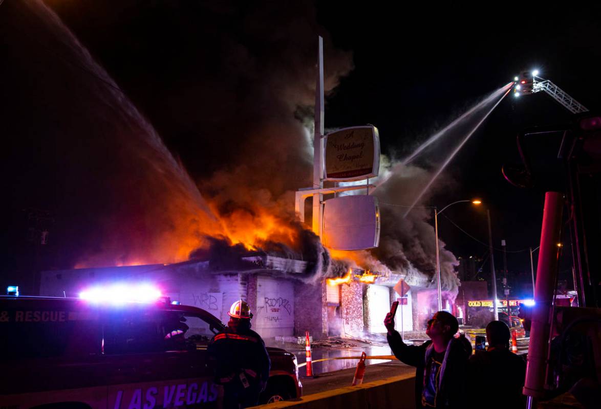 Las Vegas firefighters battle flames engulfing a vacant wedding chapel at 1431 S. Las Vegas Blv ...