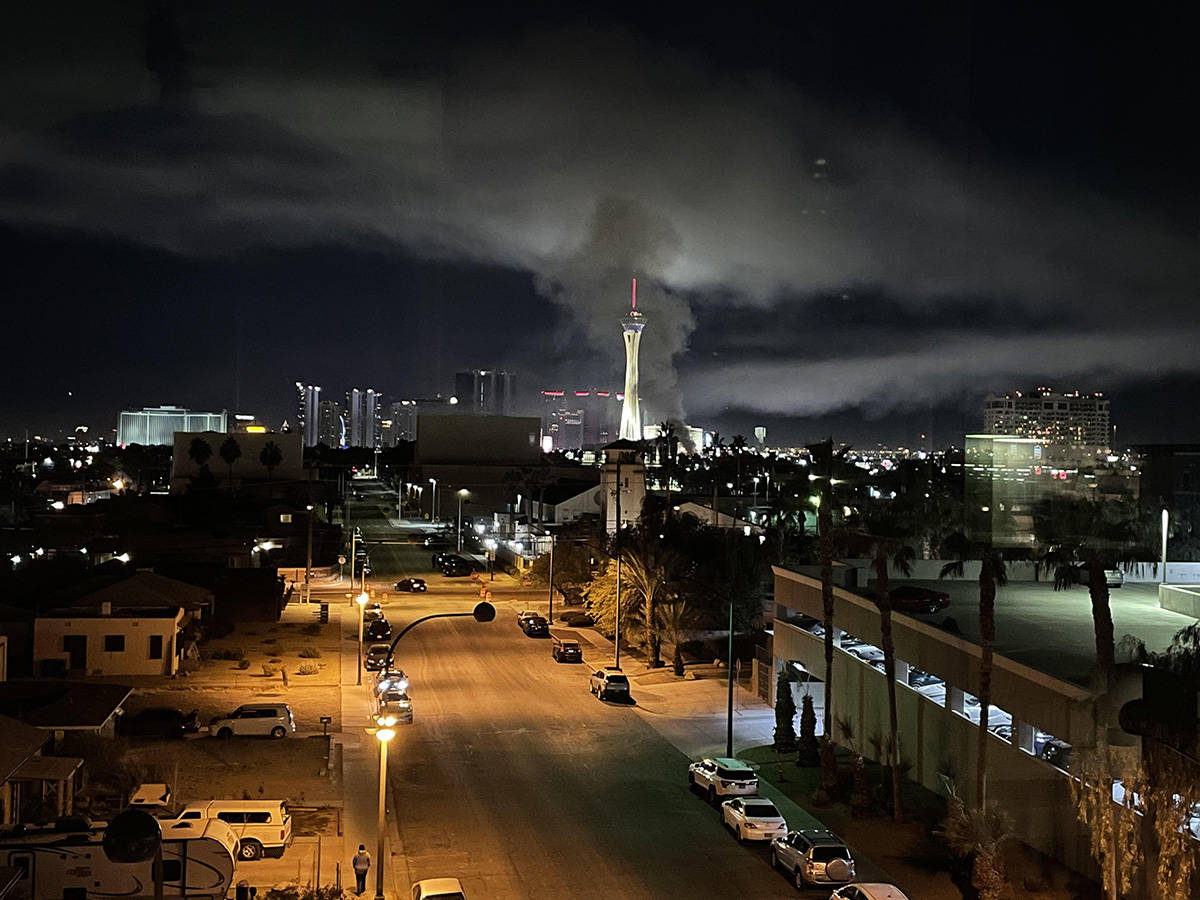 Smoke rises above The Strat as firefighters battle flames engulfing a vacant wedding chapel at ...