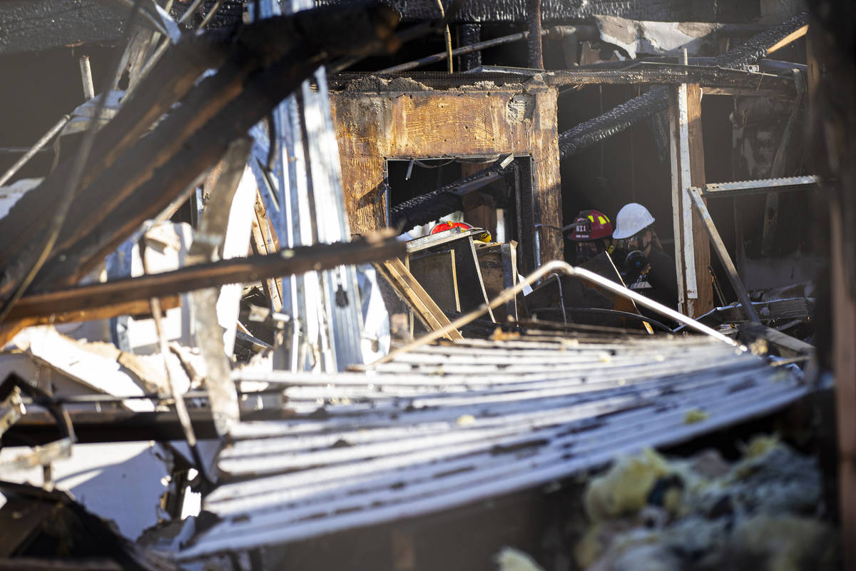 Investigators with the Clark County Coroner's Office and Las Vegas police examine the area afte ...