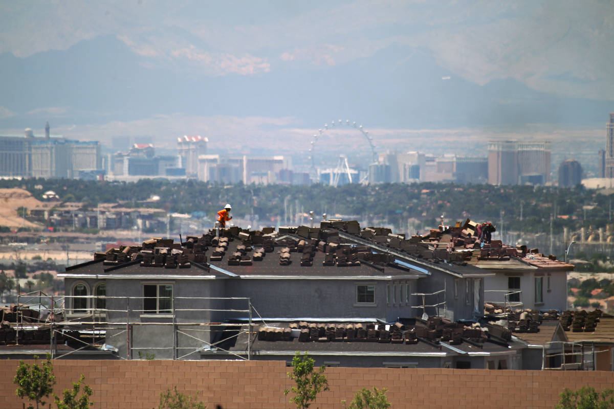 In 2015, workers are on shown on roofs building homes in Cadence, a master-planned community in ...