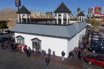 Hundreds line up outside of the Prime Valley Lotto Store as people wait to buy the Mega Million ...