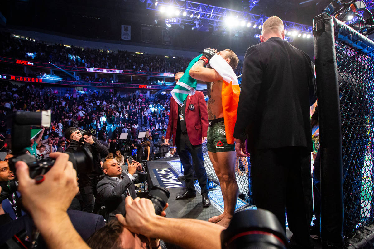 Conor McGregor motions to the crowd after defeating Donald "Cowboy" Cerrone via techn ...