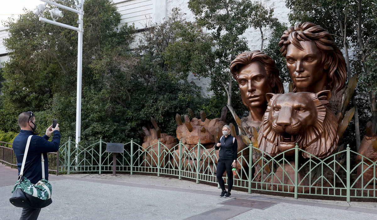 John Hayton of Chicago takes a photo of his wife Stacy Hayton in front of a statue of Siegfried ...