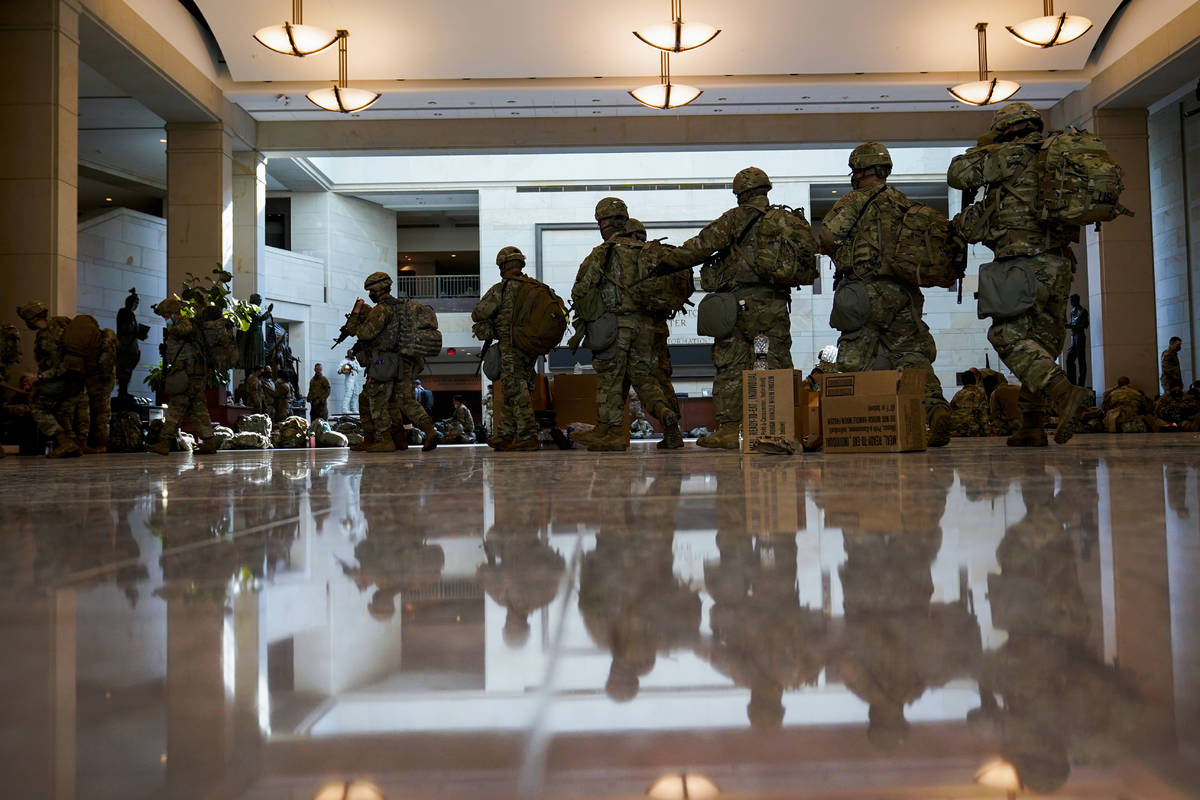 Troops move inside the Capitol Visitor's Center to reinforce security at the Capitol in Washing ...