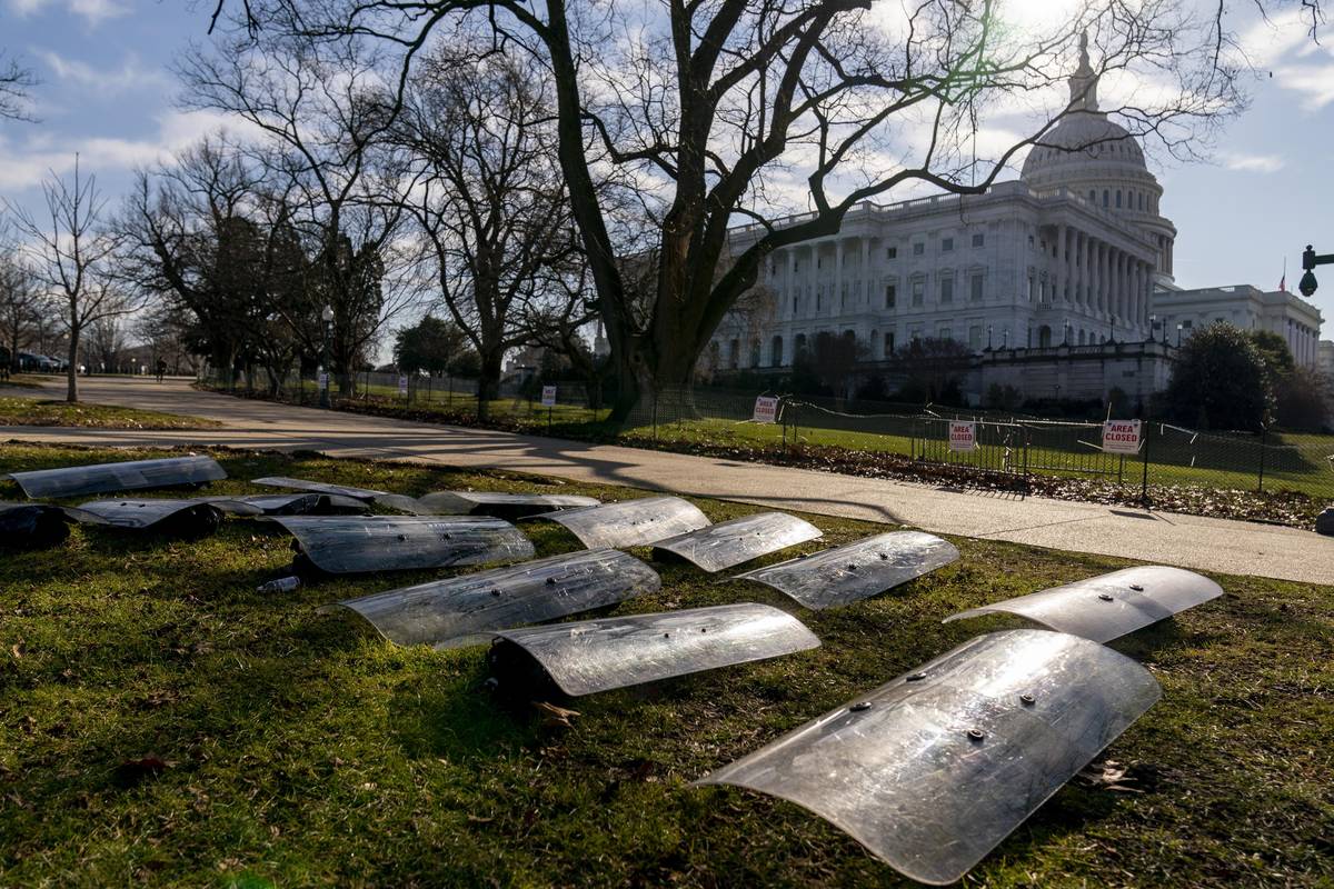 The Dome of the Capitol building is visible as riot gear is laid out on a field on Capitol Hill ...
