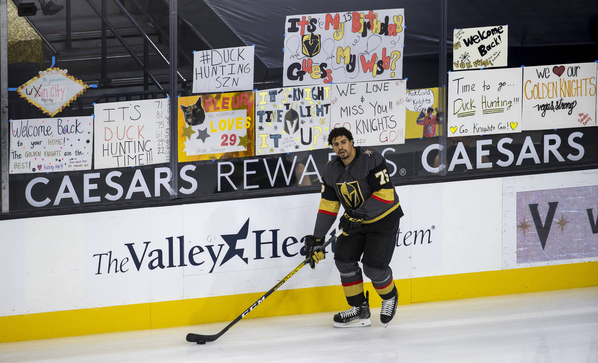 Golden Knights right wing Ryan Reaves (75) skates by handwritten signs from fans during the war ...