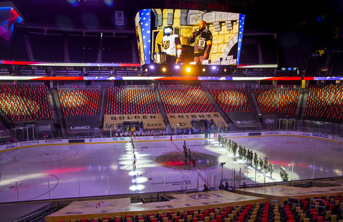 The Golden Knights stand together as Carnell Johnson sings the National Anthem before the first ...