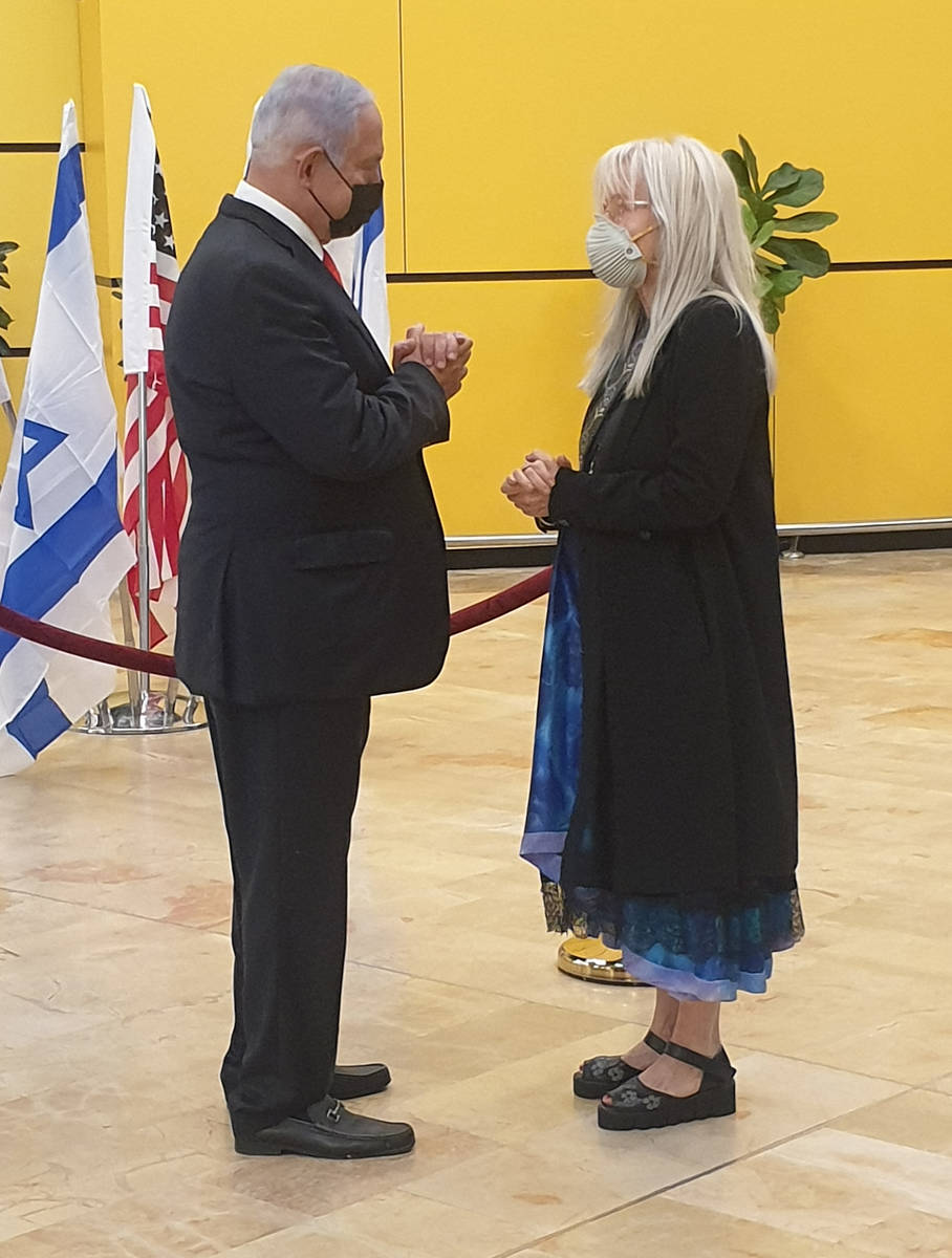 Israeli Prime Minister Benjamin Netanyahu, left, offers his condolences to Dr. Miriam Adelson o ...