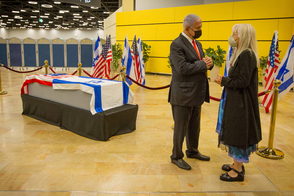 Israeli Prime Minister Benjamin Netanyahu, left, offers his condolences to Dr. Miriam Adelson o ...