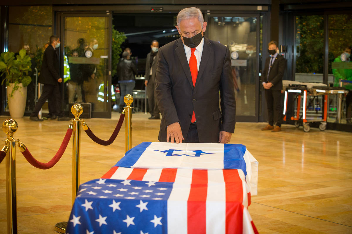 Israeli Prime Minister Benjamin Netanyahu pays his respects to Sheldon Adelson on Thursday, Jan ...
