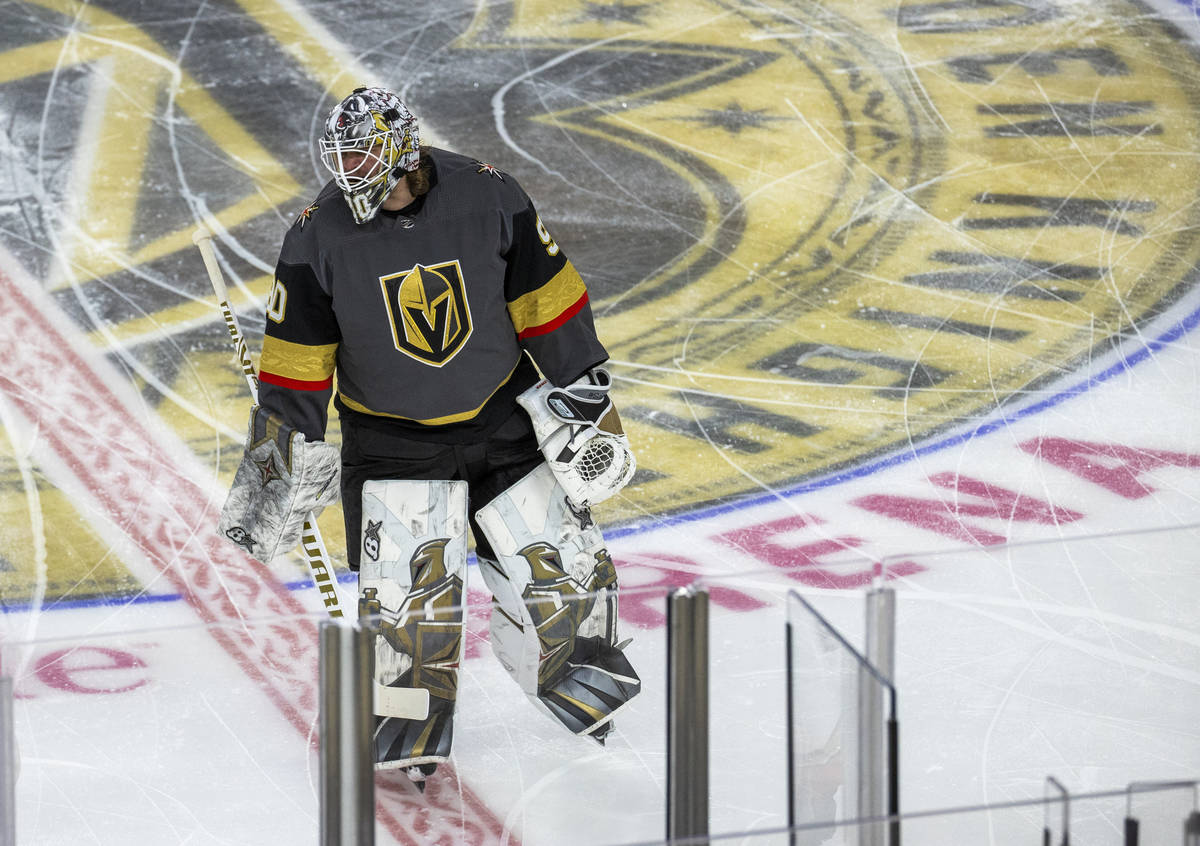 Golden Knights goaltender Robin Lehner (90) eyes Anaheim Ducks players during the warm ups of a ...