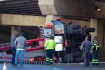 A semi-truck overturned in the eastbound lanes of Sahara Avenue at the I-15 overpass causing tr ...