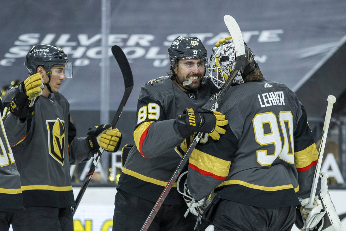 Golden Knights right wing Alex Tuch (89) congratulates Golden Knights goaltender Robin Lehner ( ...