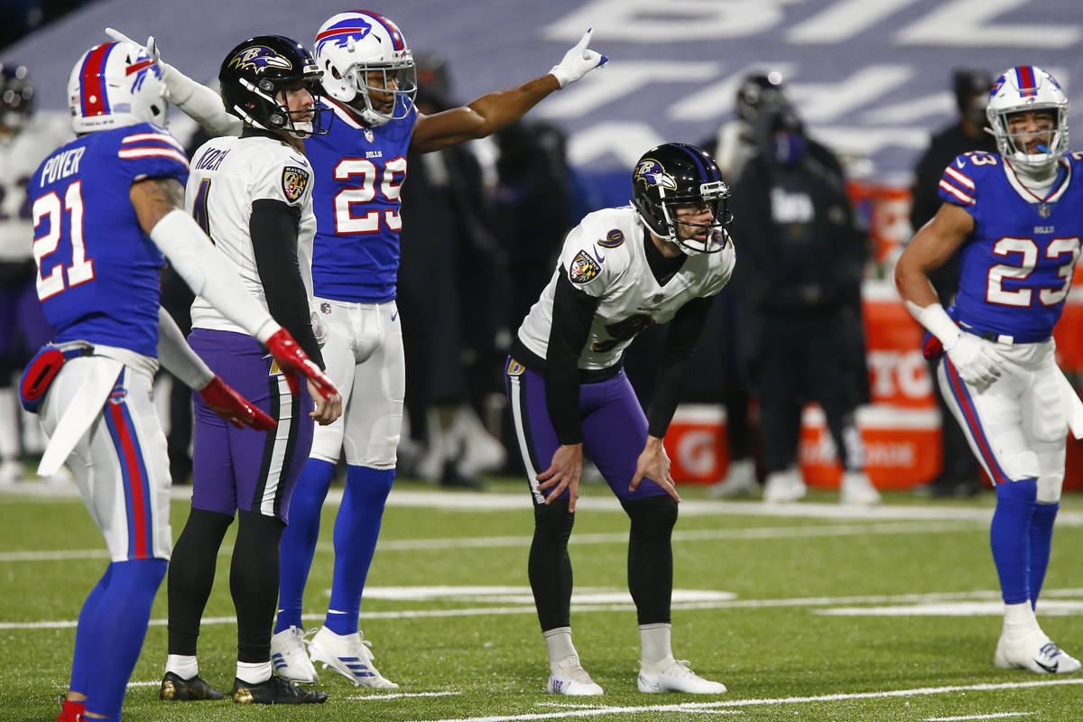 Buffalo Bills' Josh Norman (29) and Micah Hyde (23) watch as Baltimore Ravens kicker Justin Tuc ...