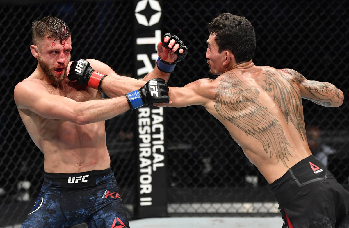 (R-L) Max Holloway punches Calvin Kattar in a featherweight bout during the UFC Fight Night eve ...