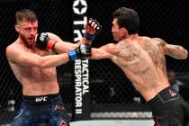 (R-L) Max Holloway punches Calvin Kattar in a featherweight bout during the UFC Fight Night eve ...