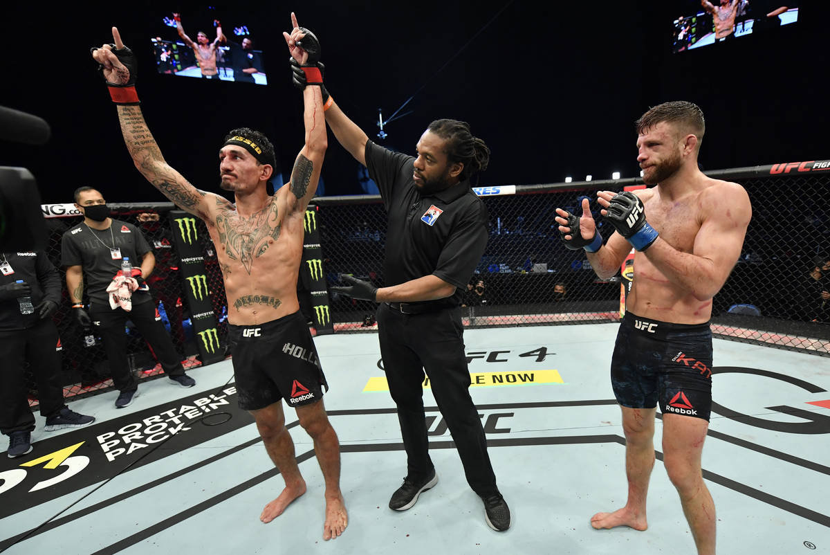 Max Holloway celebrates after his unanimous-decision victory over Calvin Kattar in a featherwei ...
