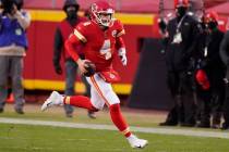 Kansas City Chiefs quarterback Chad Henne scrambles up field during the second half of an NFL d ...