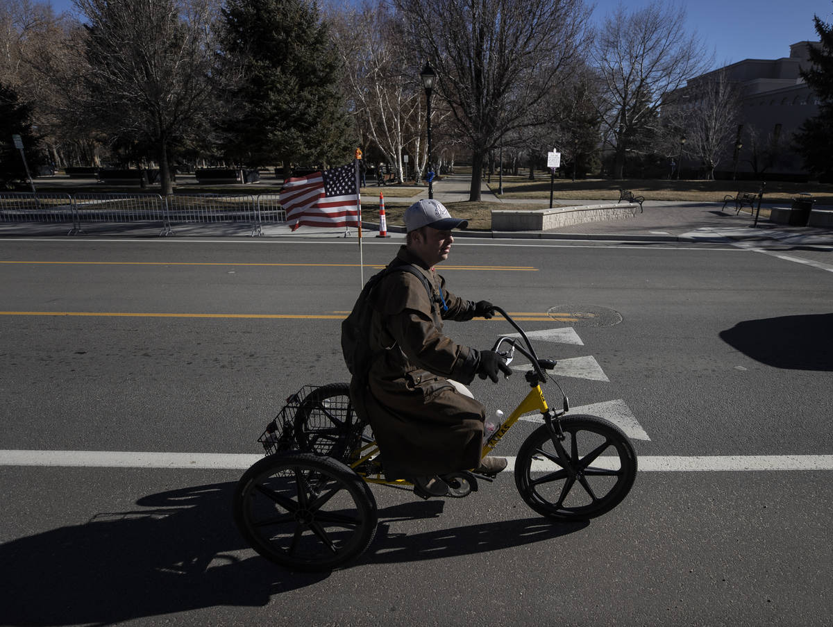 A bicyclist passes by the state Capitol complex on Sunday, Jan. 17, 2021, in Carson City, Nev. ...