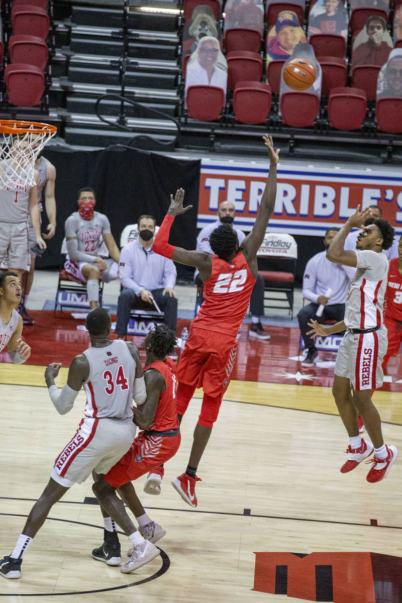 UNLV Rebels guard Bryce Hamilton (13) makes a jump shot over New Mexico Lobos forward Valdir Ma ...