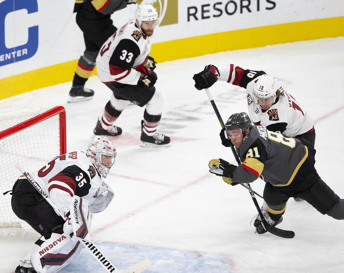 Golden Knights' center Jonathan Marchessault (91) takes a dive into the net while Arizona Coyot ...