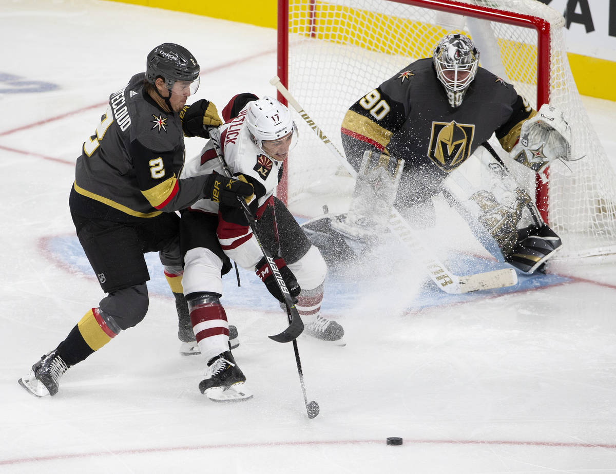 Golden Knights' defenseman Zach Whitecloud (2) shoves Arizona Coyotes' center Tyler Pitlick (17 ...