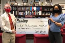 Findlay Automotive Group CFO Tyler Corder presents a check to Findlay human resources manager a ...