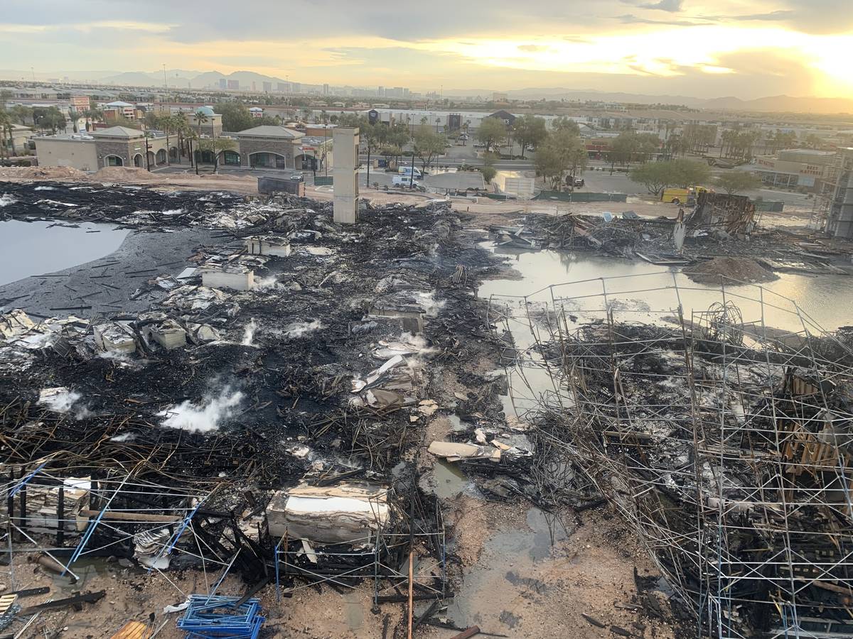 The aftermath of an overnight fire at an under-construction apartment complex in southwest Las ...