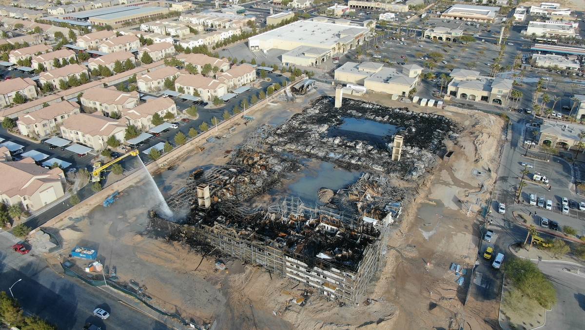 An aerial view of the damage after an overnight fire at an under-construction apartment complex ...