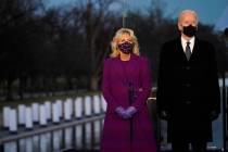 President-elect Joe Biden and Jill listen during a COVID-19 memorial, with lights placed around ...
