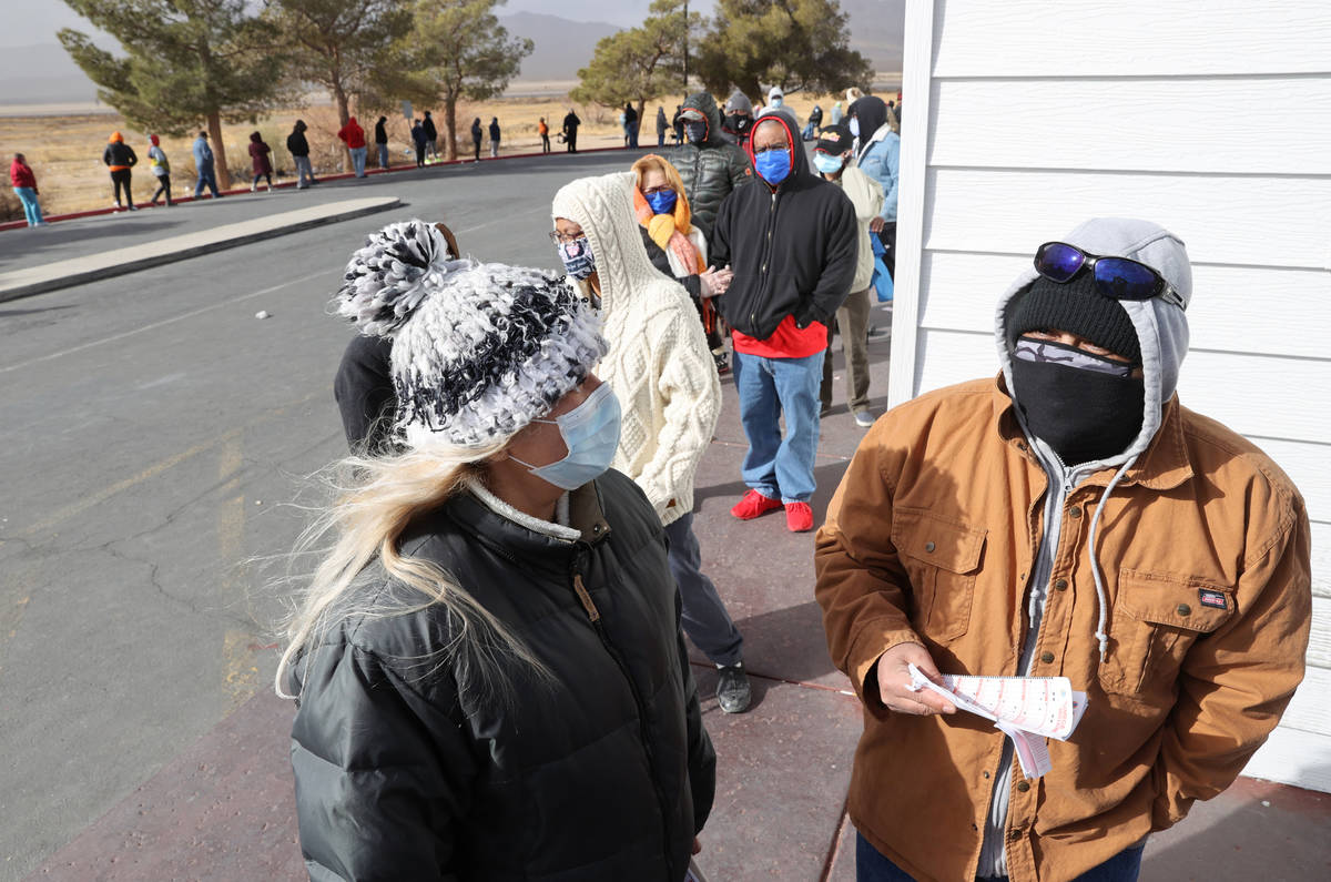 Mario Palencia, right, and Fabiola Herrera, both of Las Vegas, line up to buy Powerball and Meg ...