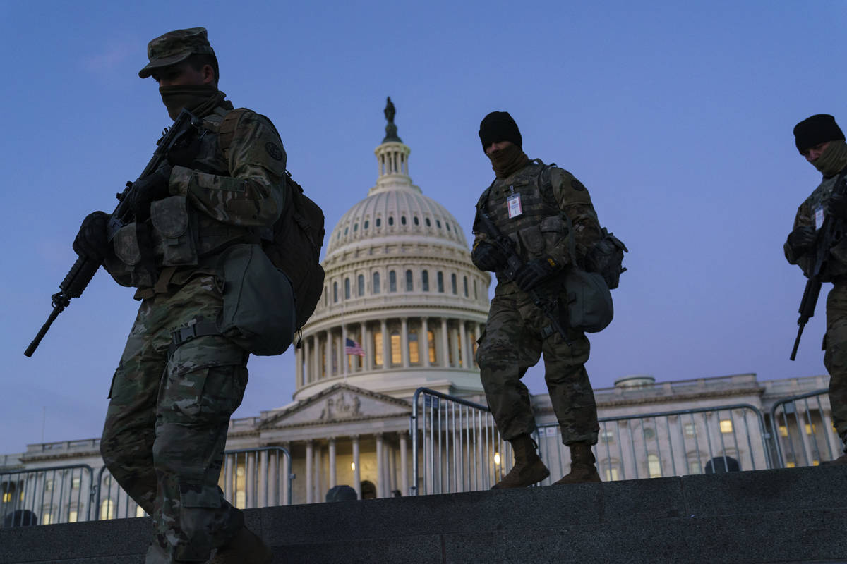 National Guard troops reinforce the security zone on Capitol Hill in Washington, Tuesday, Jan. ...