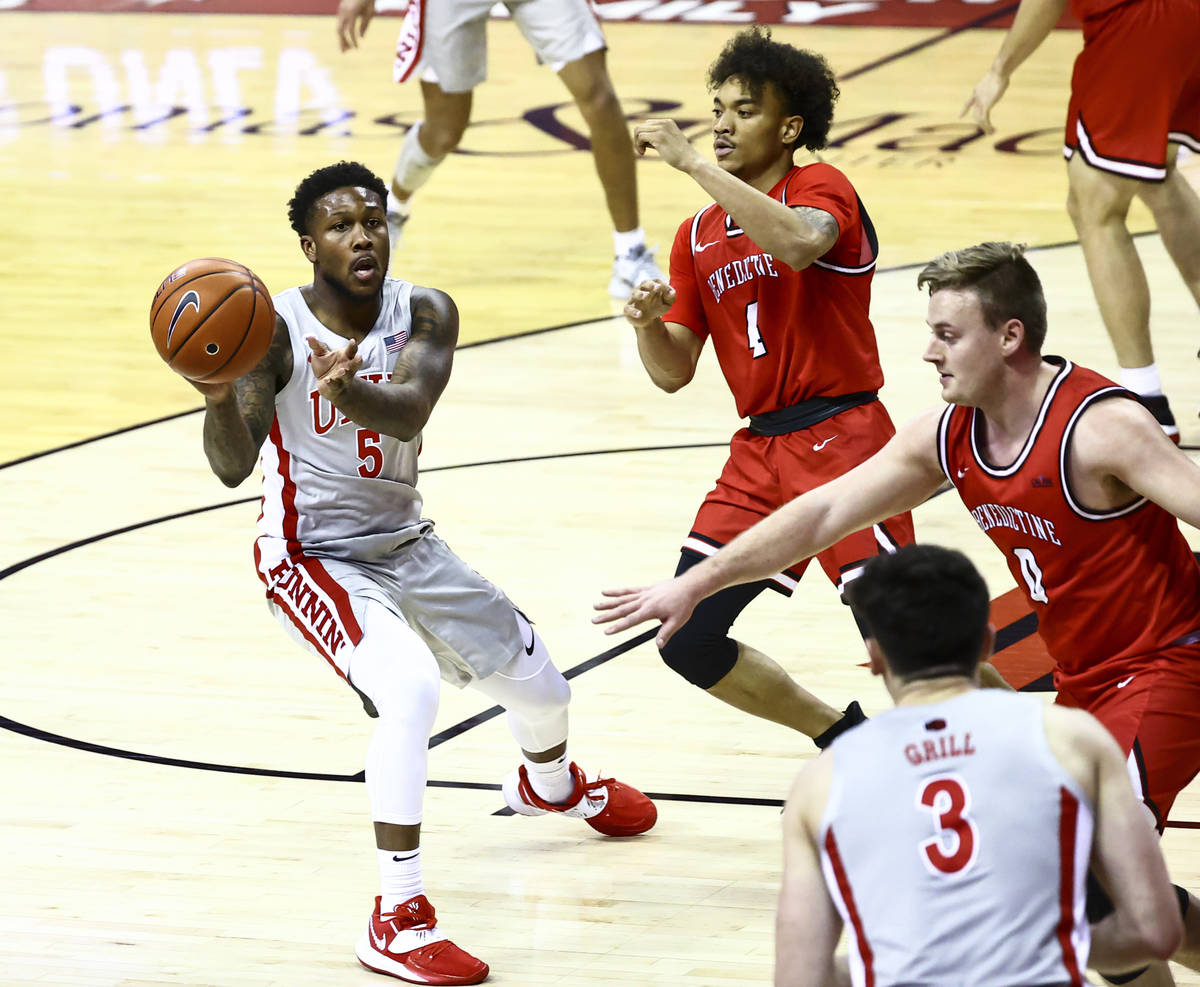 UNLV Rebels guard David Jenkins Jr. (5) passes the ball under pressure from Benedictine Mesa Re ...