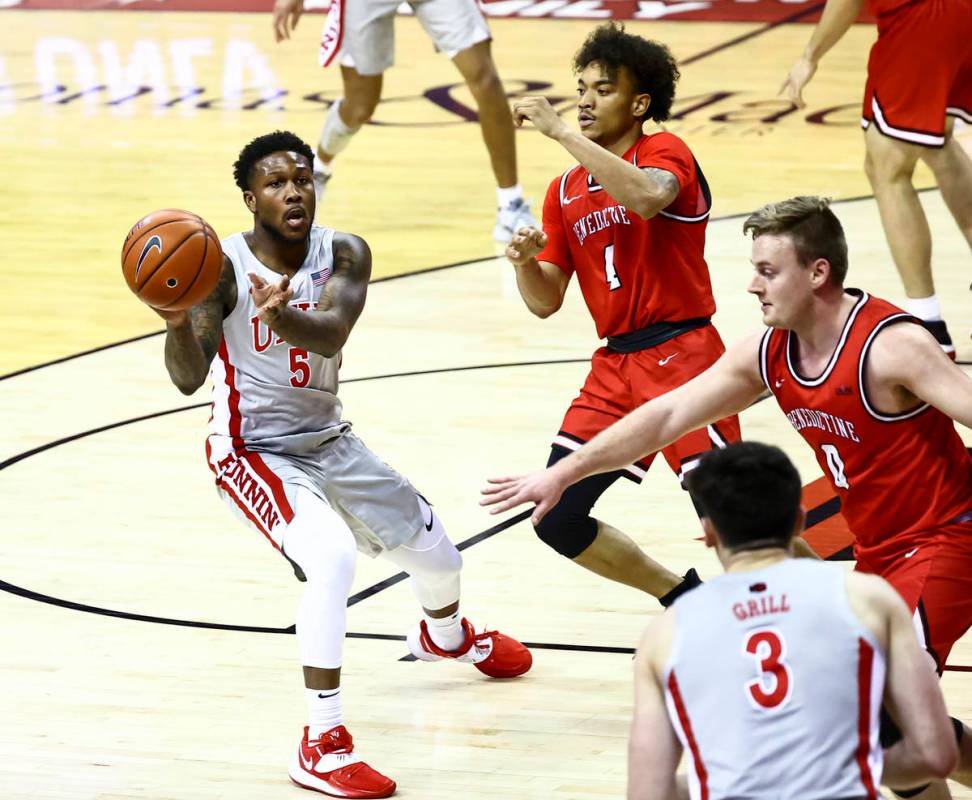 UNLV Rebels guard David Jenkins Jr. (5) passes the ball under pressure from Benedictine Mesa Re ...