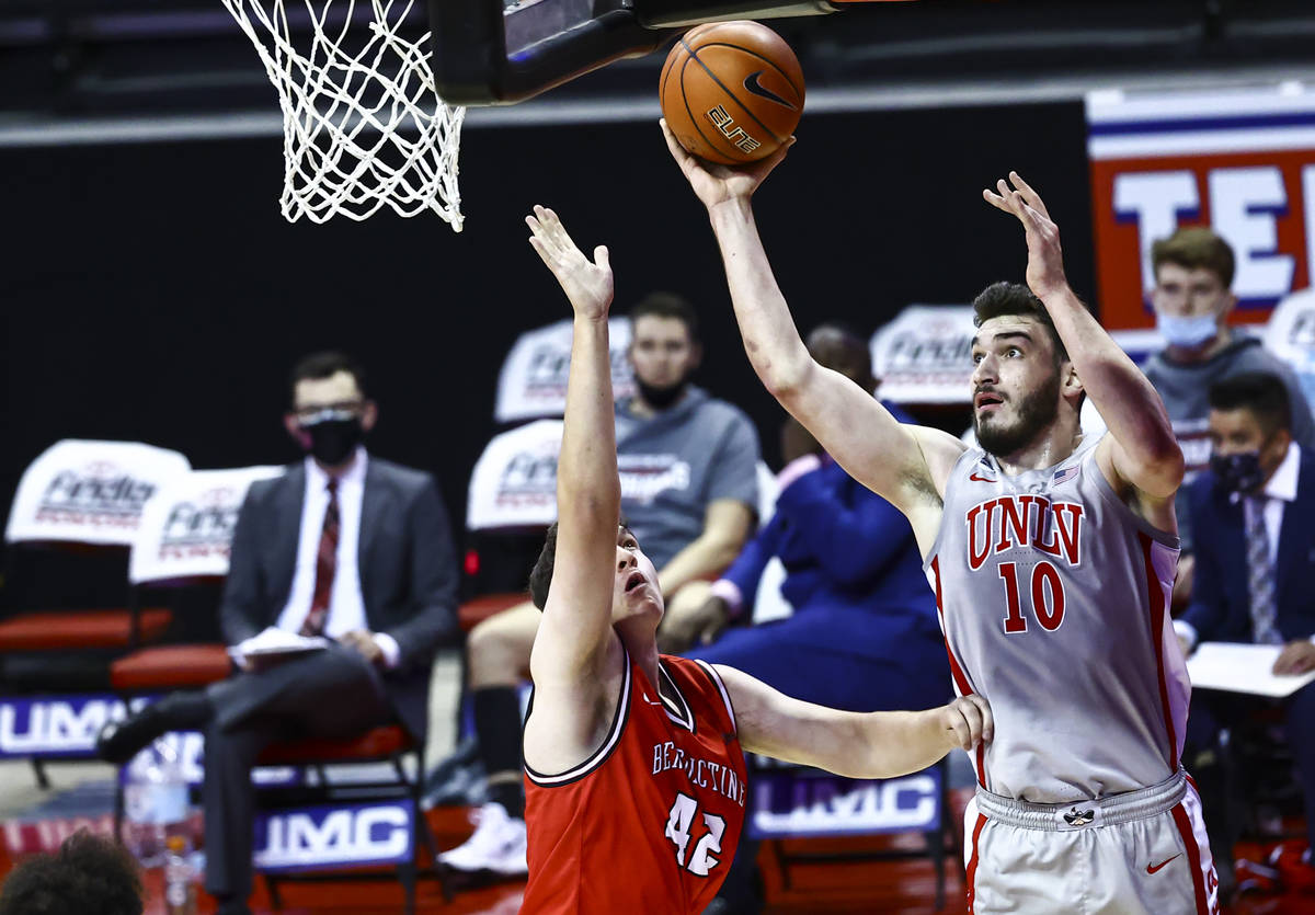 UNLV Rebels forward Edoardo Del Cadia (10) shoots over Benedictine Mesa Redhawks' Nick Sessions ...