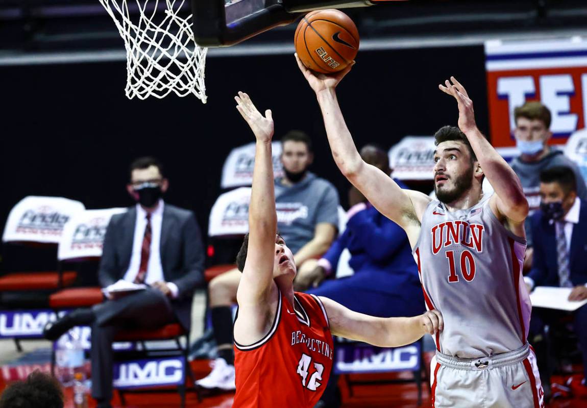 UNLV Rebels forward Edoardo Del Cadia (10) shoots over Benedictine Mesa Redhawks' Nick Sessions ...