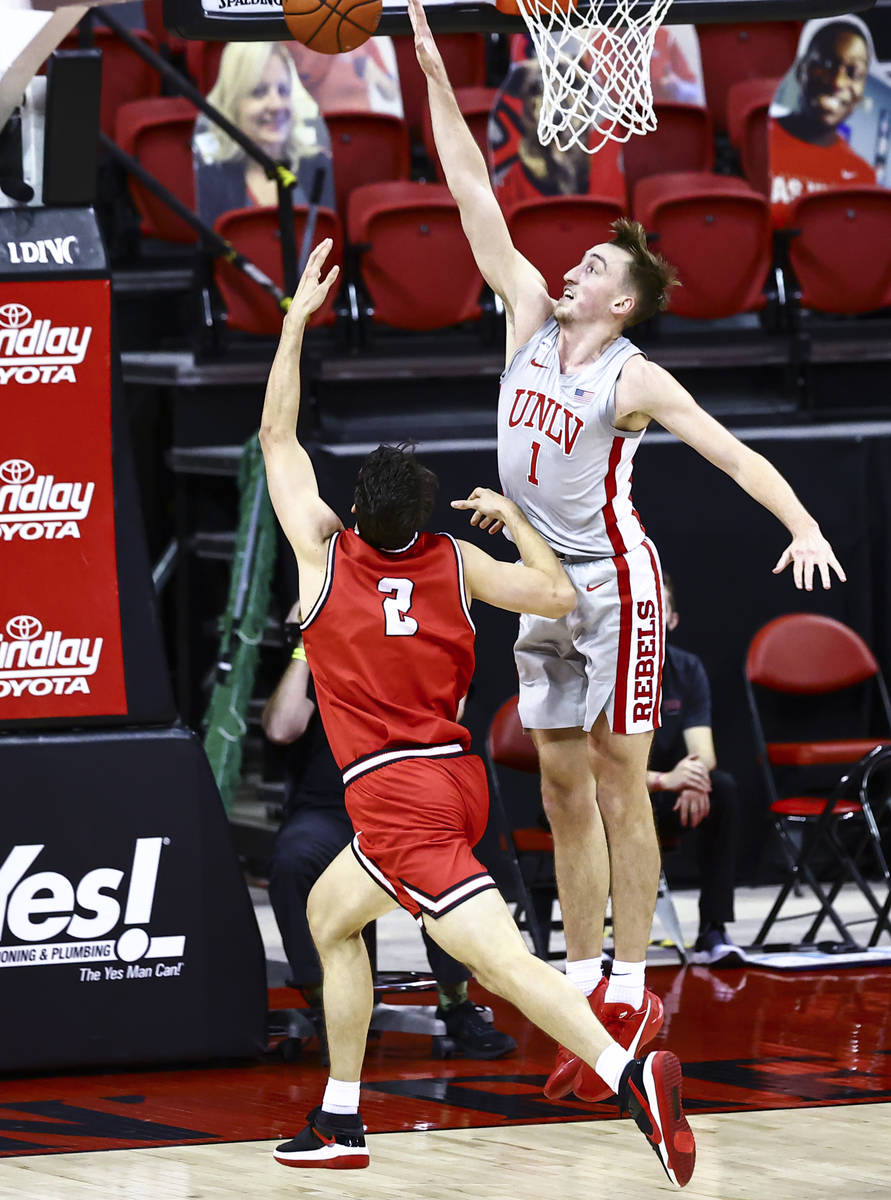 UNLV Rebels forward Moses Wood (1) looks to block a shot from Benedictine Mesa Redhawks Bryce C ...