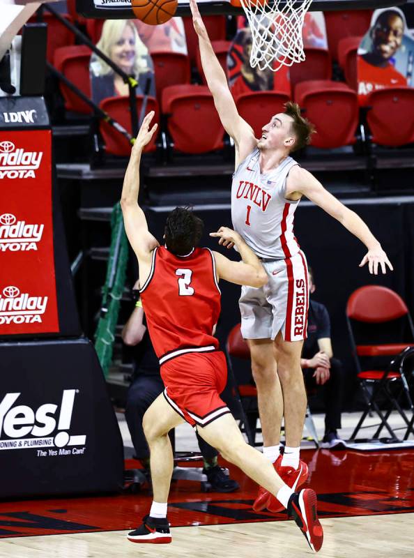 UNLV Rebels forward Moses Wood (1) looks to block a shot from Benedictine Mesa Redhawks Bryce C ...